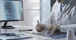 Doctor writing a medical prescription for a patient