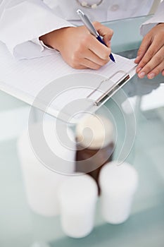 Doctor writing out prescriptions photo