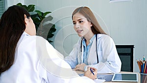 Doctor writing prescription for medical health care oncologist therapy using laptop. Two women doctors consultation with professio