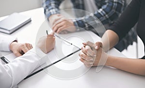 Doctor writing prescription and treatment plan to patients