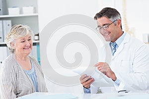 Doctor writing prescriptions for senior patient