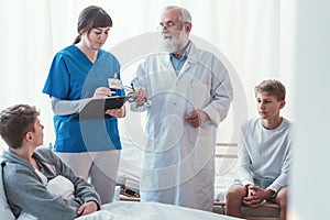 Doctor writing something on legal pad during hospital visit