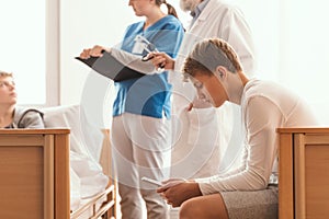 Doctor writing something on legal pad during hospital visit