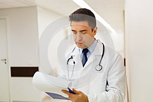 Doctor writing to clipboard at hospital