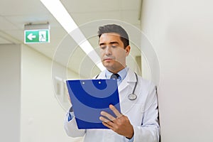 Doctor writing to clipboard at hospital