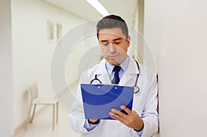 Doctor writing to clipboard at hospital