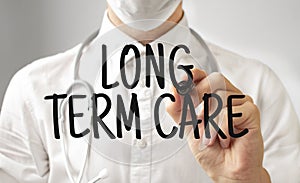 Doctor writing word LONG TERM CARE with marker, Medical concept