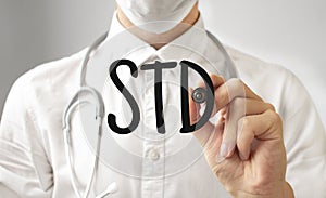 Doctor writing word STD with marker, Medical concept