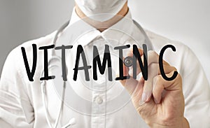 Doctor writing word VITAMIN C with marker, Medical concept