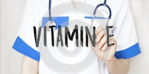 Doctor writing word Vitamin e with marker, Medical concept