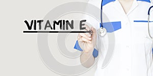 Doctor writing word Vitamin e with marker, Medical concept