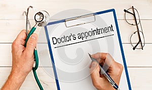 The doctor wrote - Doctor`s appointment, stethoscope, glasses, pen