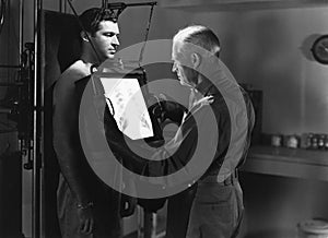 Doctor x raying patients chest