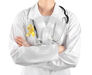 Doctor with yellow ribbon on robe against white background. Cancer awareness concept