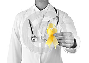 Doctor with yellow ribbon on white background. Cancer awareness concept