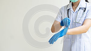 Doctor Ying in a medical mask wears gloves on his arm. isolated on white background to prevent contact contagious disease