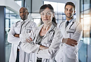 Doctoring expertise you can depend on. Portrait of a team of confident doctors standing together in a hospital.