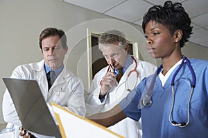 Doctors Analyzing X-Ray Report