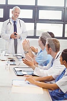 Doctors applauding a fellow doctor