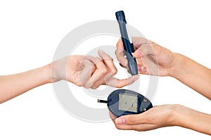 Doctors arm holding glucose meter scanner on patients finger and measure monitor in other hand