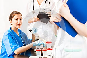 Doctors assistant working with microscope