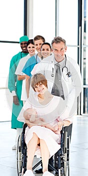 Doctors attending to a patient and her baby