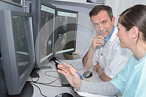 Doctors checking mri machine screens