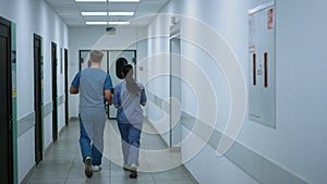 Doctors colleagues walking down corridor talking about work. Medics consulting.