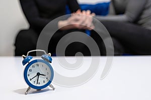 Doctors consultation with patients in the hospital office. Clock on the table in the office of a psychologist. Health concept,