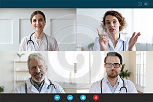 Doctors engaged in distant communication by videocall computer screen view