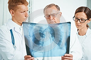 Doctors examine x-ray image in clinic