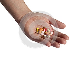 Doctors hand holding many colorful pills isolated on white background. Drugs, medication addiction. Drug abuse and dependency