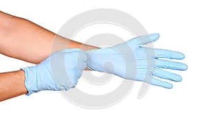 Doctors hands putting in nitrile exam blue latex gloves isolated photo