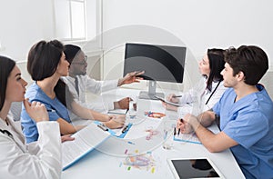 Doctors having lecture and taking notes in meeting room
