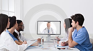 Doctors Having Online Video Call Conference At Computer In Office