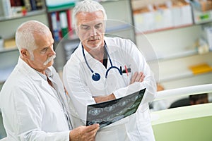 Doctors holding xray in medical office