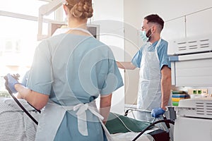 Doctors in internal department of hospital performing endoscopy