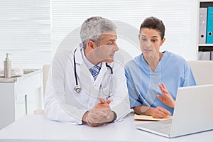 Doctors looking at laptop photo