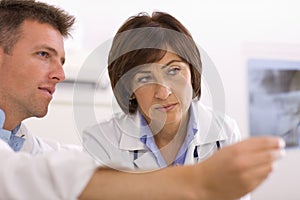 Doctors looking at x-ray image