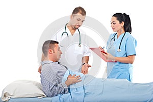 Doctors with male patient in hospital