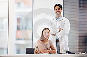 Doctors, man and woman with arms crossed in portrait, smile and hospital office with leadership for medical job. Clinic