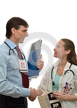 Doctors man and woman shaking hands, congratulating success