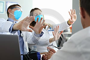 Doctors in medical masks disagree with colleagues