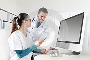 Doctors with nurse looking medical records, concept of consult