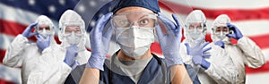 Doctors or Nurses In Hazmat Medical Personal Protective Equipment PPE Against The American Flag Banner