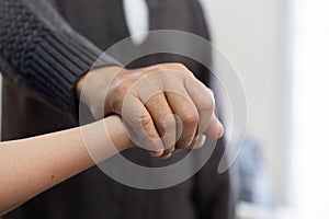 Doctors or nurses hold hands of elderly patients to support and soothe