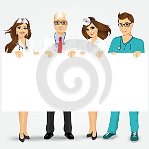 Doctors and nurses holding a blank billboard