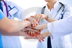 Doctors and nurses in a medical team stacking