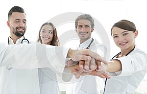 Doctors and nurses in a medical team stacking hands