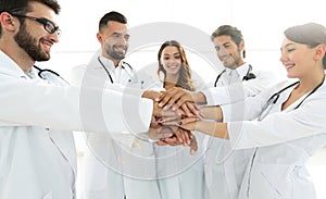 Doctors and nurses in a medical team stacking hands